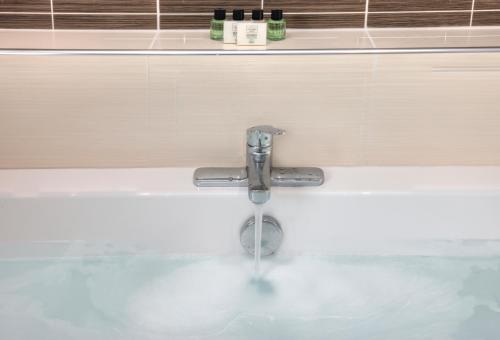 a bathroom sink with a water faucet at Beach Houses with Hot Tubs in Glencoe