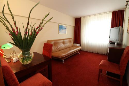 a living room with a couch and a table at Hotel Adria in Rumia