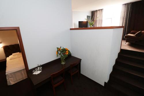 a hotel room with a desk and a mirror and a room at Hotel Adria in Rumia