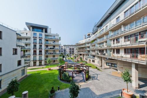 an apartment building with a playground in a courtyard at Ludwinowska11 Apartments in Kraków