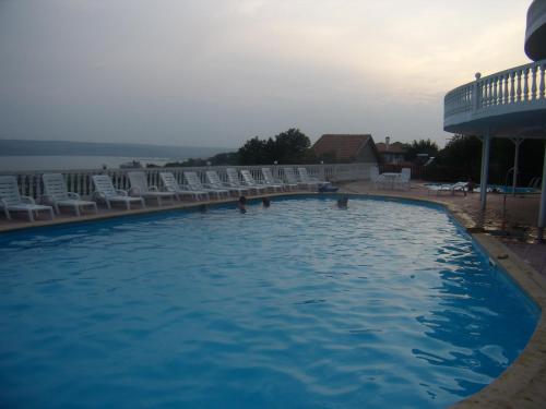 a swimming pool with a pool table and chairs at Family Hotel Casablanca Green in Varna City