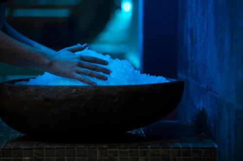 a person is mixing a bowl of snow at Hôtel Daria-I Nor by Les Etincelles in L'Alpe-d'Huez