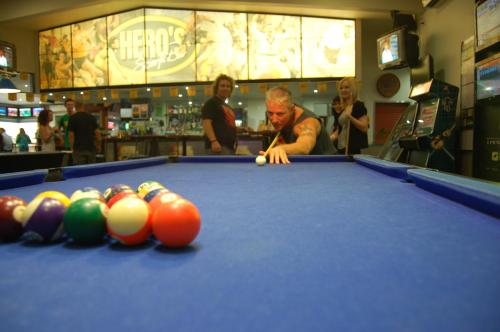 a man playing a game of pool in a pool table at Slipway Hotel Motel in Ballina