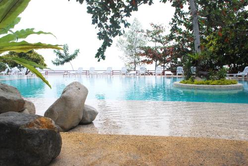 a swimming pool with some rocks in the water at Almont Beach Resort in Surigao