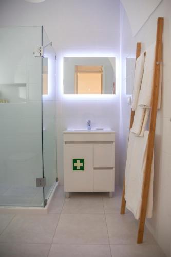 a bathroom with a sink and a glass shower at Casa do Colégio Downtown Private Suite 61 in Ponta Delgada