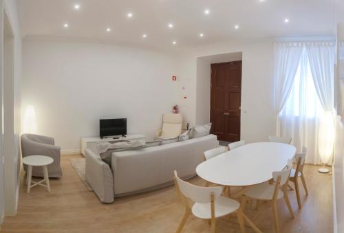 a living room with a couch and a table at Casa do Colégio Downtown Private Suite 61 in Ponta Delgada