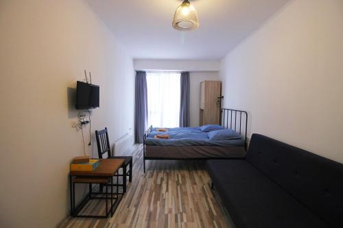 a living room with a couch and a bed at Apartment N107 Gudauri Loft in Gudauri
