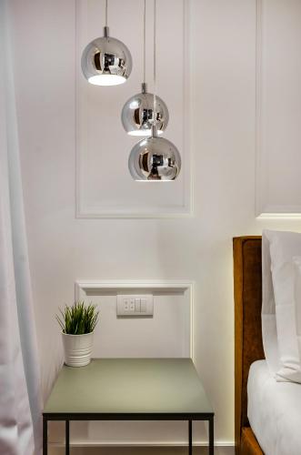a table with a plant on it next to a bed at Room 25 Belgrade in Belgrade