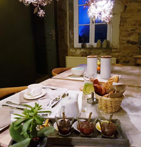 a table with a tray of food on a table at Moulin Renaudiots - Maison d'hôtes in Autun