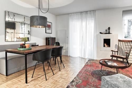 a living room with a dining room table and chairs at Cityapartment Graz in Graz