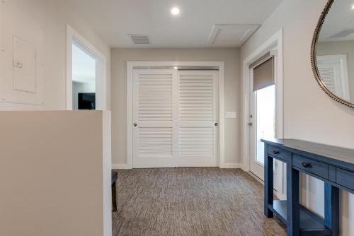 a hallway with a door and a mirror at Escape Coastal Resort on Casey Key in Nokomis