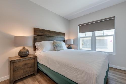 a bedroom with a large bed and a window at Escape Coastal Resort on Casey Key in Nokomis