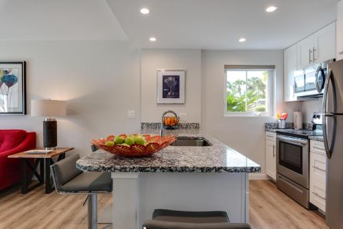 a kitchen with a bowl of fruit on a counter at Escape Coastal Resort on Casey Key in Nokomis