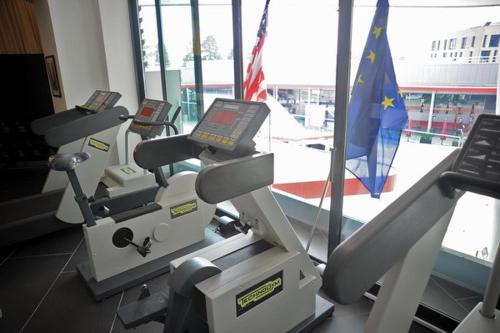 a gym with two machines in a room with a flag at Hotel Rivarolo in Rivarolo Canavese