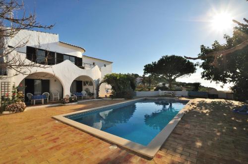 a swimming pool in front of a house at VIVENDA JOHANNA in Lagos