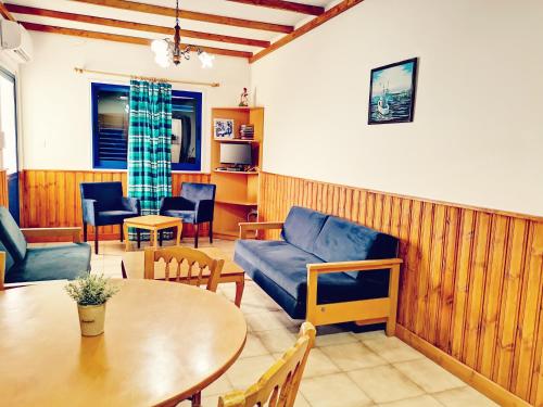 a living room with a couch and a table at Kanalli Apartments in Pomos