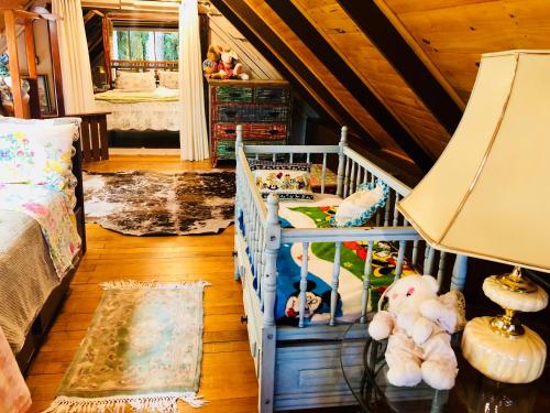 a bedroom with a crib with stuffed animals in it at Casa de Ines em Santana in São Marcos