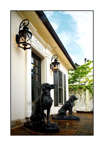 a statue of two dogs in front of a building at Old Ivy Walk in Niagara on the Lake
