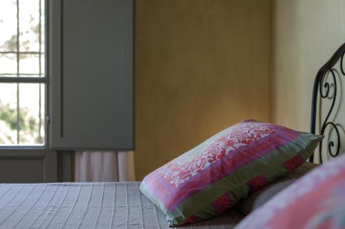 a bedroom with a bed with a pillow on it at Podere San Niccola in Punta Ala