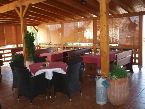 a restaurant with tables and chairs in a pavilion at Hotel Orion in Ivanec