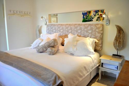 a bedroom with a large bed with white pillows at Watson Park in Yankalilla