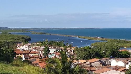 a view of a town and a body of water at Azul Kitnets in Santa Cruz Cabrália