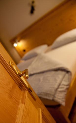 a close up of ajar door of a bed at Agritur Renetta in Tassullo