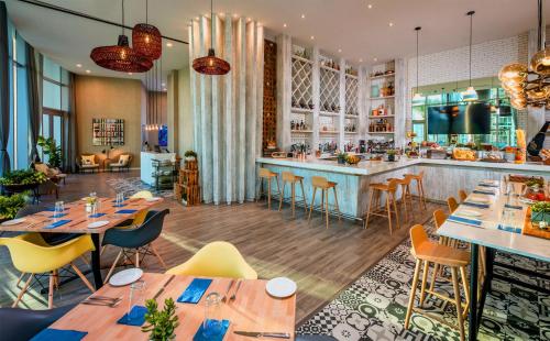 a restaurant with wooden tables and chairs and a bar at Luxury Beach Resort in Hollywood