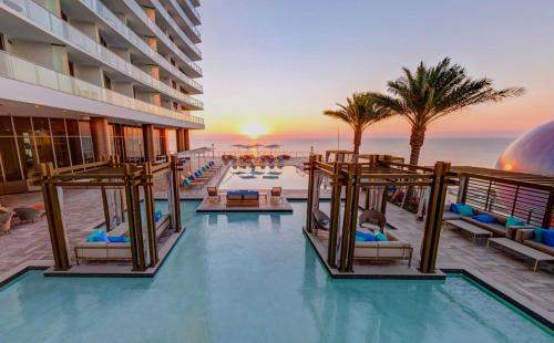 a pool at a hotel with a view of the ocean at Luxury Beach Resort in Hollywood