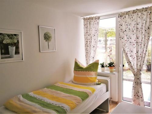 a small bedroom with a bed with a window at Central-Apt at Lake, CityCenter 5min, Fair 18min!!! in Nürnberg
