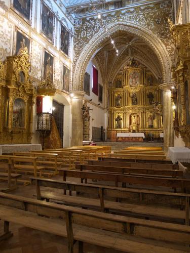 a church with a bunch of wooden pews in it at Piso Con Terraza y Vistas Espectaculares in Carmona