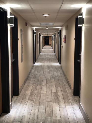 a hallway of an office building with a long corridor at Super 8 by Wyndham Bedford DFW Airport West in Bedford