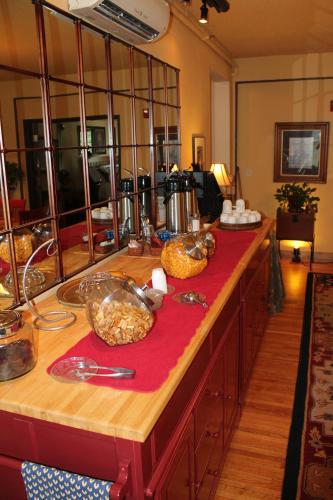 a kitchen counter with a red counter top with food on it at Iowa House Historic Inn in Ames