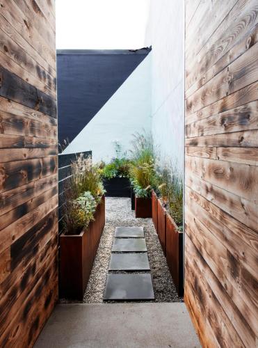 a hallway with wooden walls and potted plants at Lokal Hotel Fishtown in Philadelphia