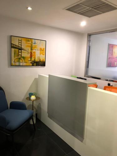 a waiting room with a chair and a window at Homy Residence in Hong Kong