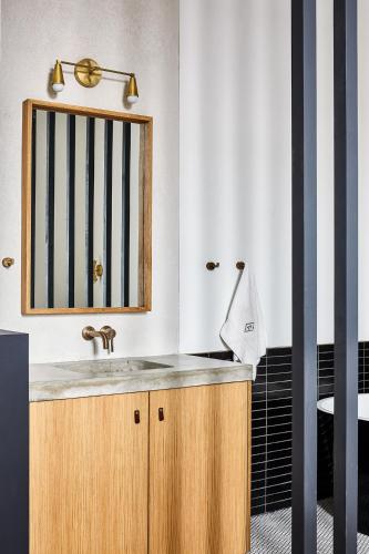 a bathroom with a wooden sink and a mirror at Lokal Hotel Fishtown in Philadelphia