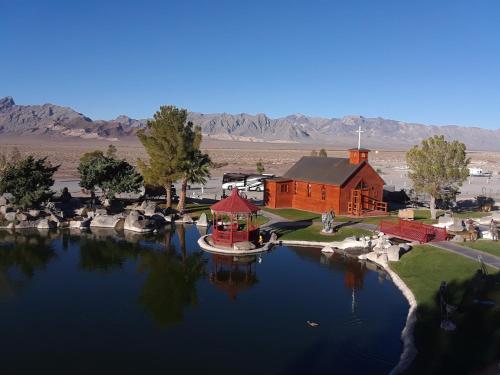 a boat in a lake in front of a red building at Longstreet Inn & Casino in Amargosa Valley
