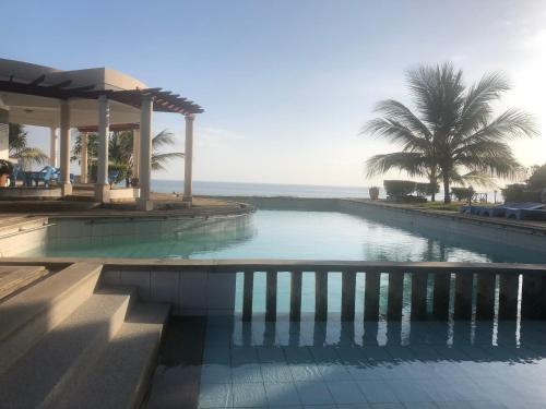 a swimming pool with a view of the ocean at Almasi Oceanfront Nyali in Mombasa