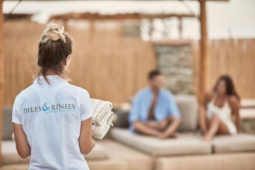 a woman looking at a man and a woman at Diles & Rinies in Tinos Town