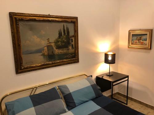 a living room with a couch and a painting on the wall at lungomare portoturistico in Chiavari