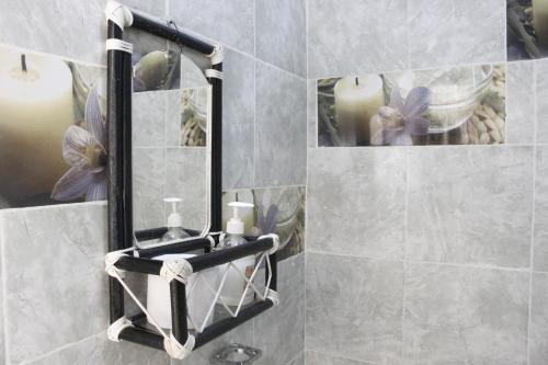 a bathroom with a towel rack and a mirror at Apartamentos Arpushana in Ríohacha