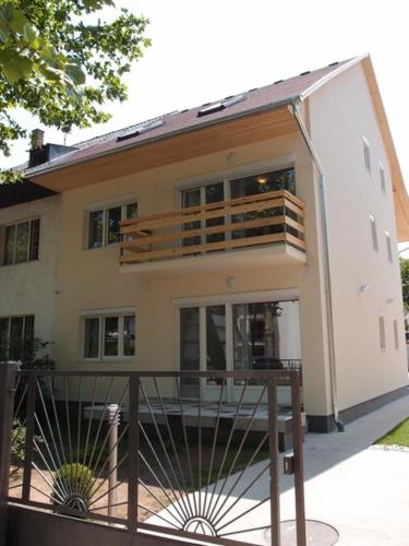a large house with a balcony on the side of it at Sió Lodge in Siófok