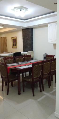 a dining room with a table and chairs at Golden Queen Suites in Baguio