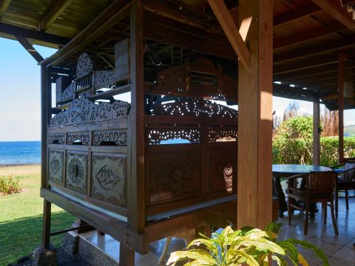 a pavilion with a table and chairs and a building at Jasri Bay Hideaway in Jasri