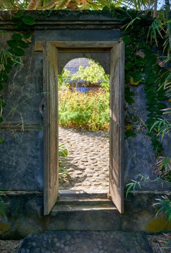 an open door leading to a brick path at Jasri Bay Hideaway in Jasri