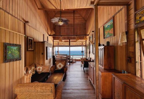 a train room with couches and a ceiling fan at Jasri Bay Hideaway in Jasri