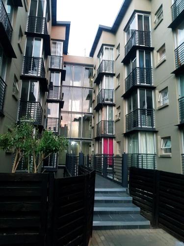 a building with balconies and stairs in front of it at The Bridgeview in Johannesburg