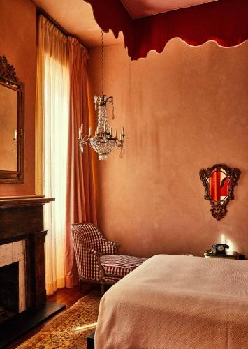 a bedroom with a bed and a chandelier at Hotel Peter and Paul, an Ash Hotel in New Orleans