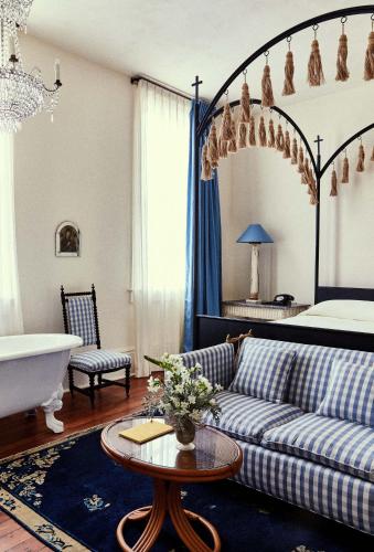 a living room with a couch and a bed at Hotel Peter and Paul, an Ash Hotel in New Orleans