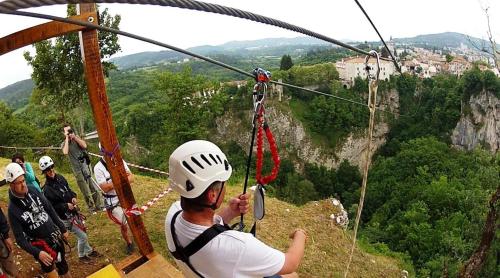 a man in a helmet on a zip line on the mountain at Farm stay Synergia - Hiden treasure in Pazin